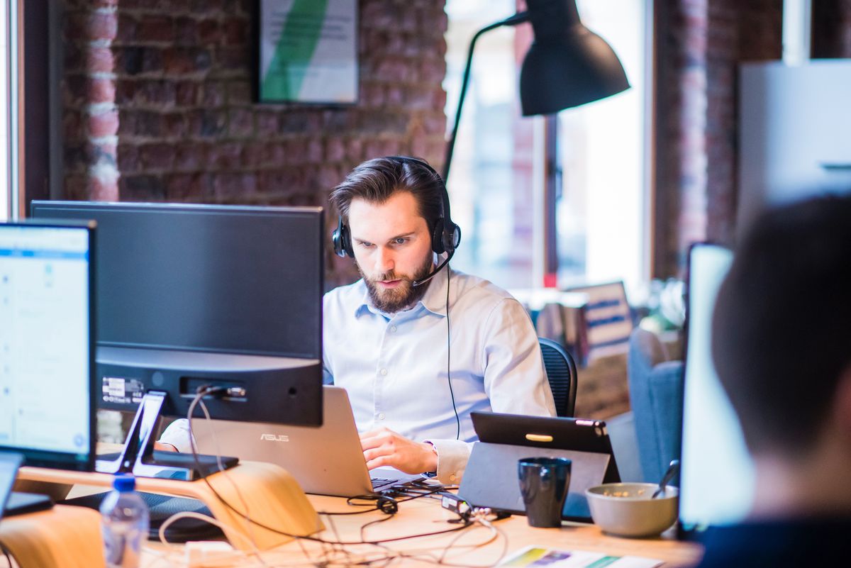 selective-focus-photo-of-man-in-official-shirt-sitting-in-2451645.jpg